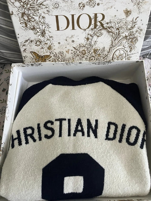 Christian Dior beanie in a box with Dior branding on the lid.