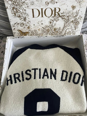 Christian Dior beanie in a box with Dior branding on the lid.