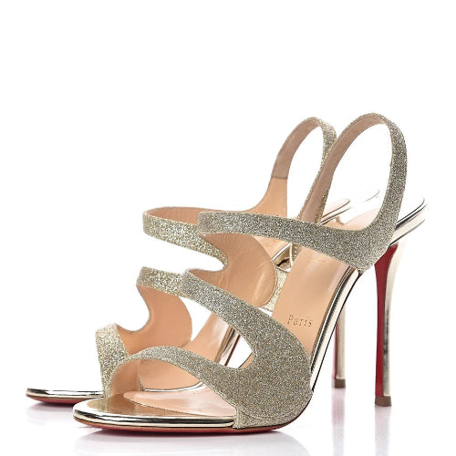 Silver high-heeled sandals on a white background