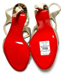 Red high-heeled shoes with gold straps on a white background