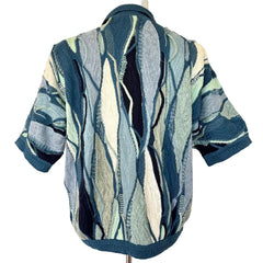 Short-sleeve shirt with a blue and green pattern on a mannequin against a white background