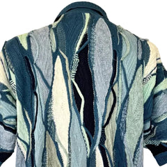 Patterned sweater with abstract design on a mannequin against a plain background