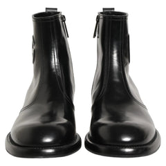 A pair of black leather ankle boots with elastic side panels and side zippers, shown against a plain white background.