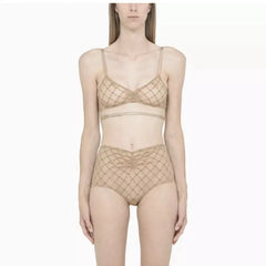 Woman wearing beige lace lingerie set on a white background