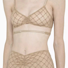 Beige lace bra and panties set on a white background