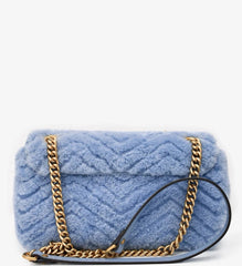 Blue textured handbag with gold chain strap on a white background