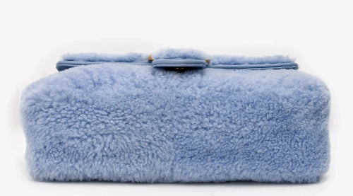 Blue fluffy bag on a white background