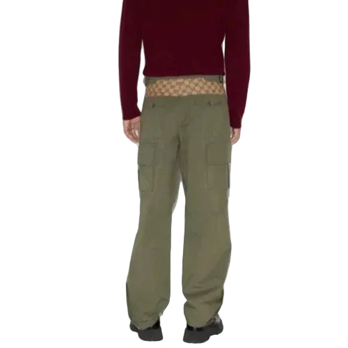 Person wearing green cargo pants with a red sweater and patterned underwear on a white background