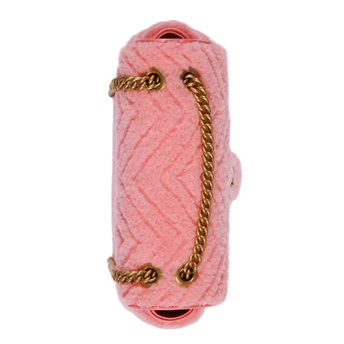 Pink knitted clutch with a gold chain on a white background