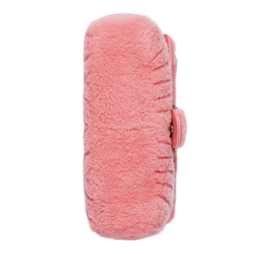 Pink fuzzy pouch on a light gray background