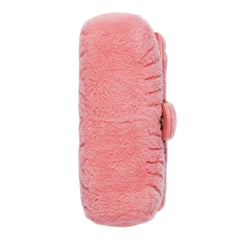 Pink fuzzy pouch on a light gray background