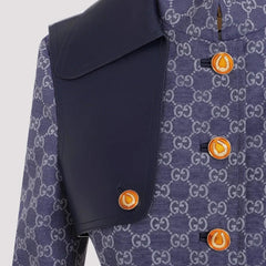 Navy blue coat with orange buttons and a patterned background