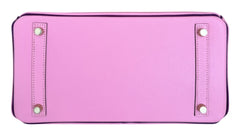 Pink wallet with decorative studs on a white background