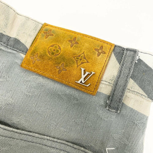 Close-up of a Louis Vuitton label on a denim garment with a white background