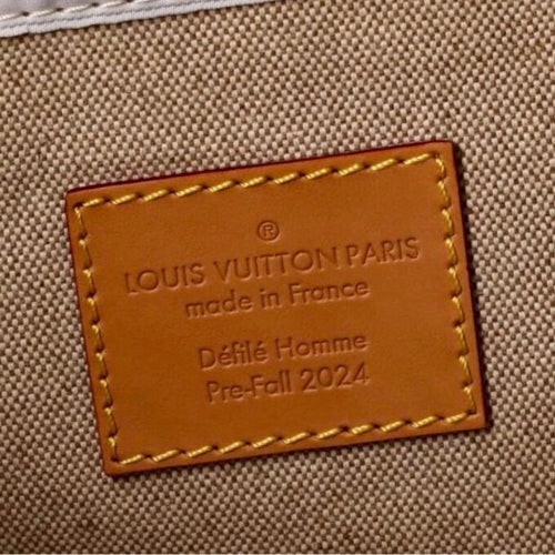 Louis Vuitton label on a textured beige background