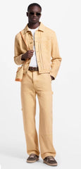 Man wearing a beige jacket and pants with a white shirt underneath on a white background