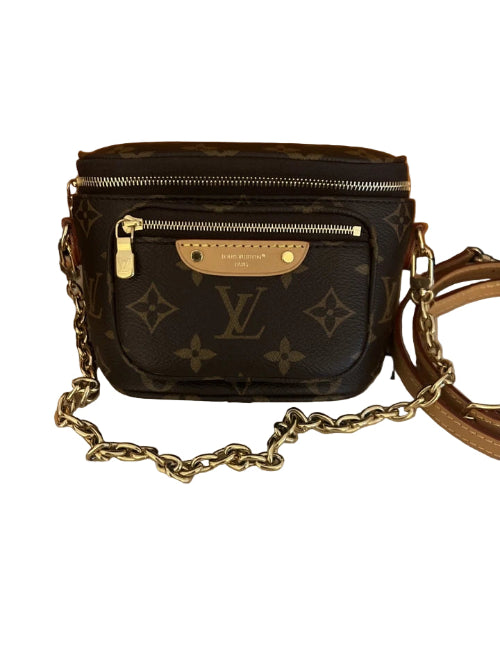 Designer handbag with gold chain strap on a white background