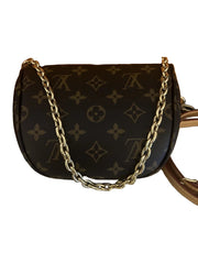 Designer handbag with gold chain strap on a white background