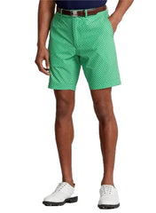 Person wearing green checkered shorts on a white background
