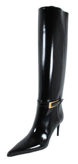 Black knee-high boot with a gold buckle on a white background