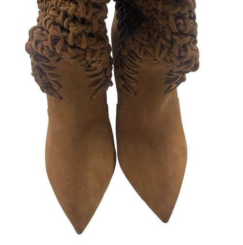Pair of brown suede boots with woven ankle straps on a light gray background
