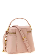 Pink handbag with gold accents on a white background