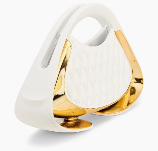 A modern, sculptural handbag with a glossy white exterior, a quilted white center panel, and prominent metallic gold side accents, shown on a clean white background.