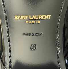 Close-up of a black leather shoe insole with gold Saint Laurent Paris branding, 'Made in Italy' text, and size '46' stamped on a glossy surface.