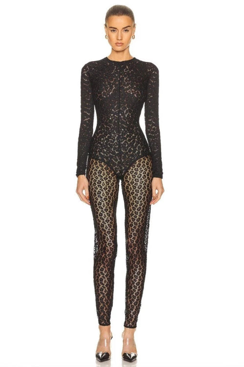 Person wearing a black lace bodysuit on a white background