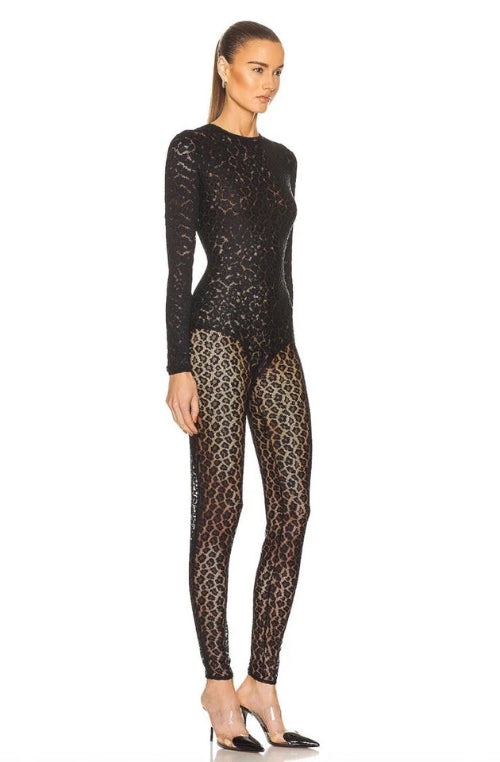 Woman wearing a black long-sleeve top and leopard print leggings on a white background