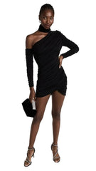 Woman wearing a black one-shoulder dress with long sleeves on a white background