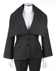 A dark gray wool-blend blazer with a dramatic wide lapel collar, three front buttons, and flap pockets, displayed on a white mannequin torso against a white background.