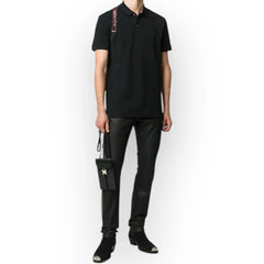 Person wearing a black outfit with a white background