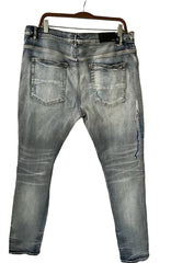 Light wash blue denim jeans shown from the back, hanging on a wooden hanger against a plain white wall.