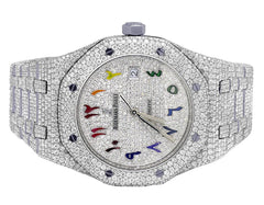 Luxury watch with diamond-studded case and colorful face on a white background