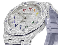 Luxury watch with diamond-studded case and colorful hour markers, brand 'Audemars Piguet' visible.