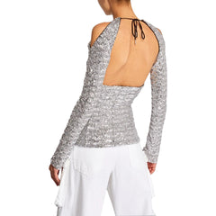 Silver sequin top with long sleeves and open back on a plain background