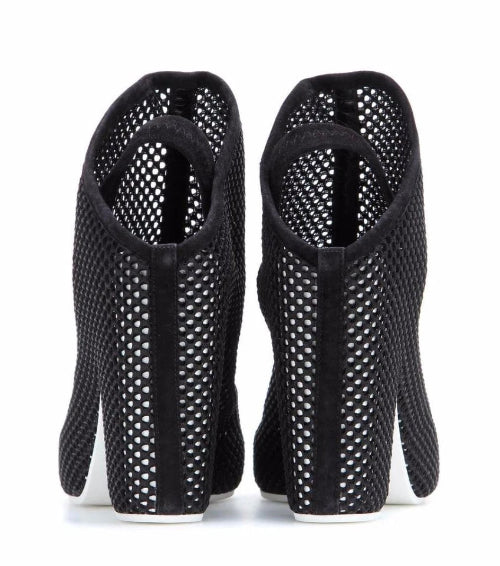 Black high-heeled shoes with open-toe design on a white background
