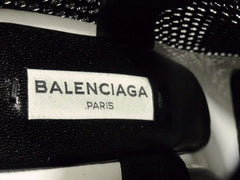 Balenciaga label on a black textured surface