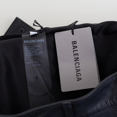 Black Balenciaga shoes with tags on a light gray background