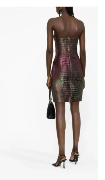 Woman wearing a strapless, iridescent dress on a white background