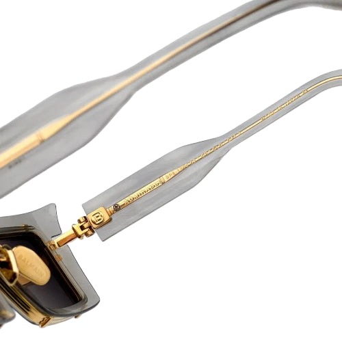 Close-up of a gold and black electronic cable with connectors.