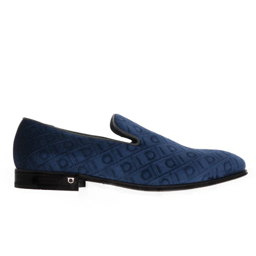 A single navy blue suede slip-on loafer with an embossed monogram pattern, shown in profile against a plain white background.
