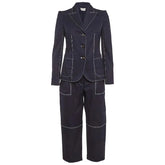 A dark navy blue two-piece suit with contrasting light gray piping details, featuring a double-breasted blazer and matching trousers, shown against a light gray background.