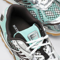 Close-up of a sneaker with 'Bottega Veneta' branding on a light background