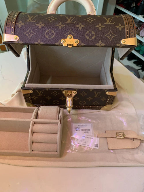 Louis Vuitton jewelry box with accessories on a light surface