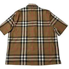 A short-sleeve plaid button-up shirt laid flat on a white background. The shirt features a classic check pattern in brown, beige, black, and white with thin red accent lines.