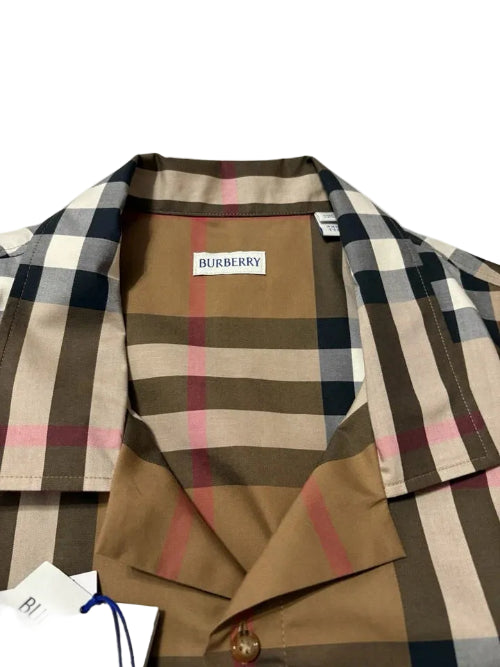 A close-up of a classic check plaid jacket in beige, brown, and black, with a brown suede collar and a tan interior lining.