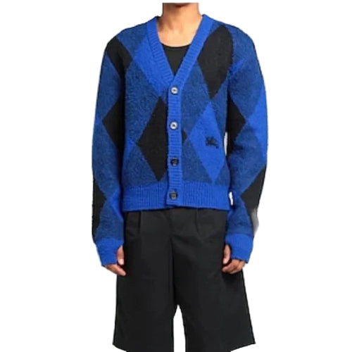 Blue and black argyle patterned cardigan worn by a person on a plain background