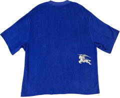 Blue t-shirt with a white logo on the back against a beige background
